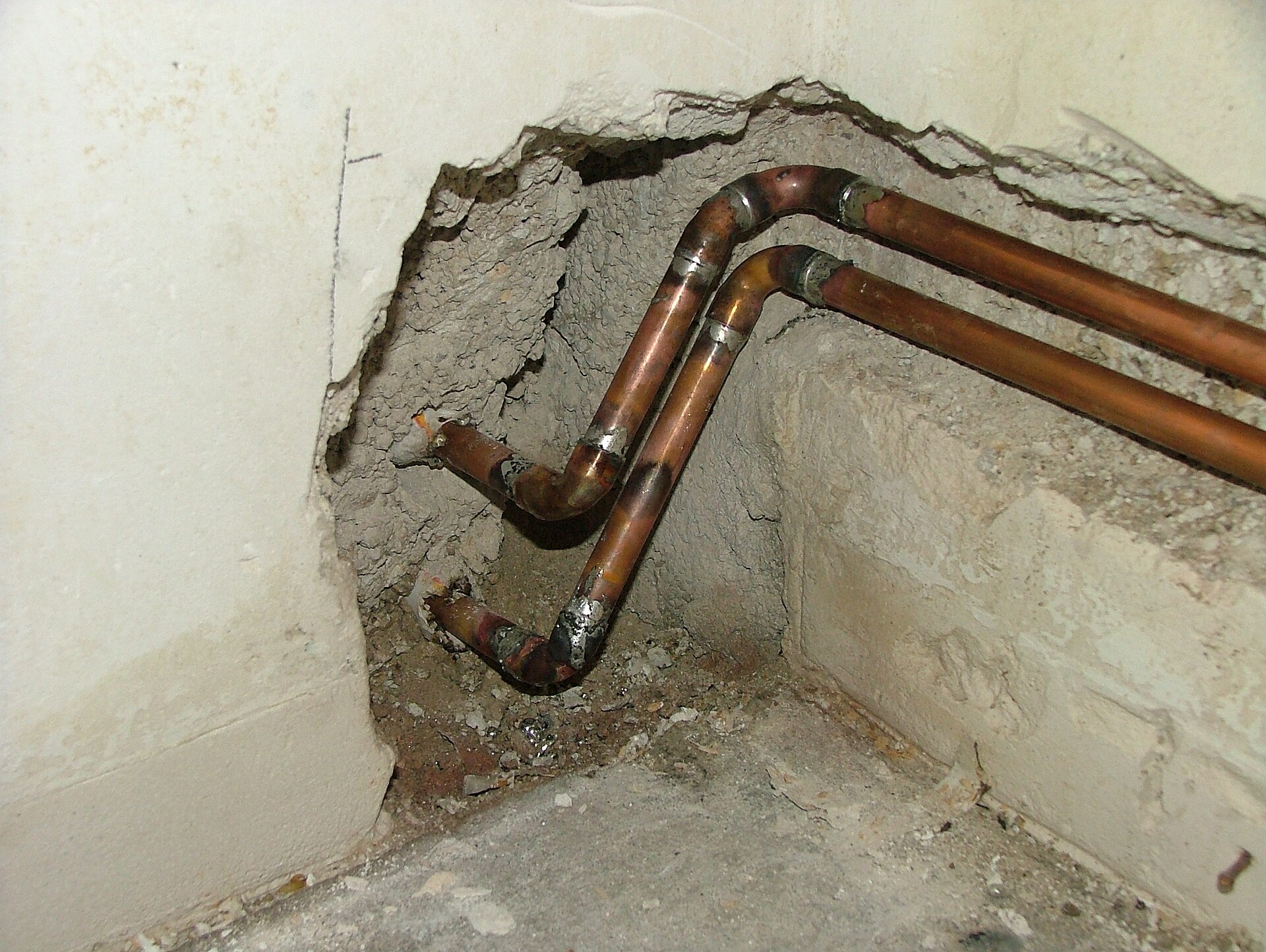 Copper pipe fittings, elbows and tees, laid out in a row