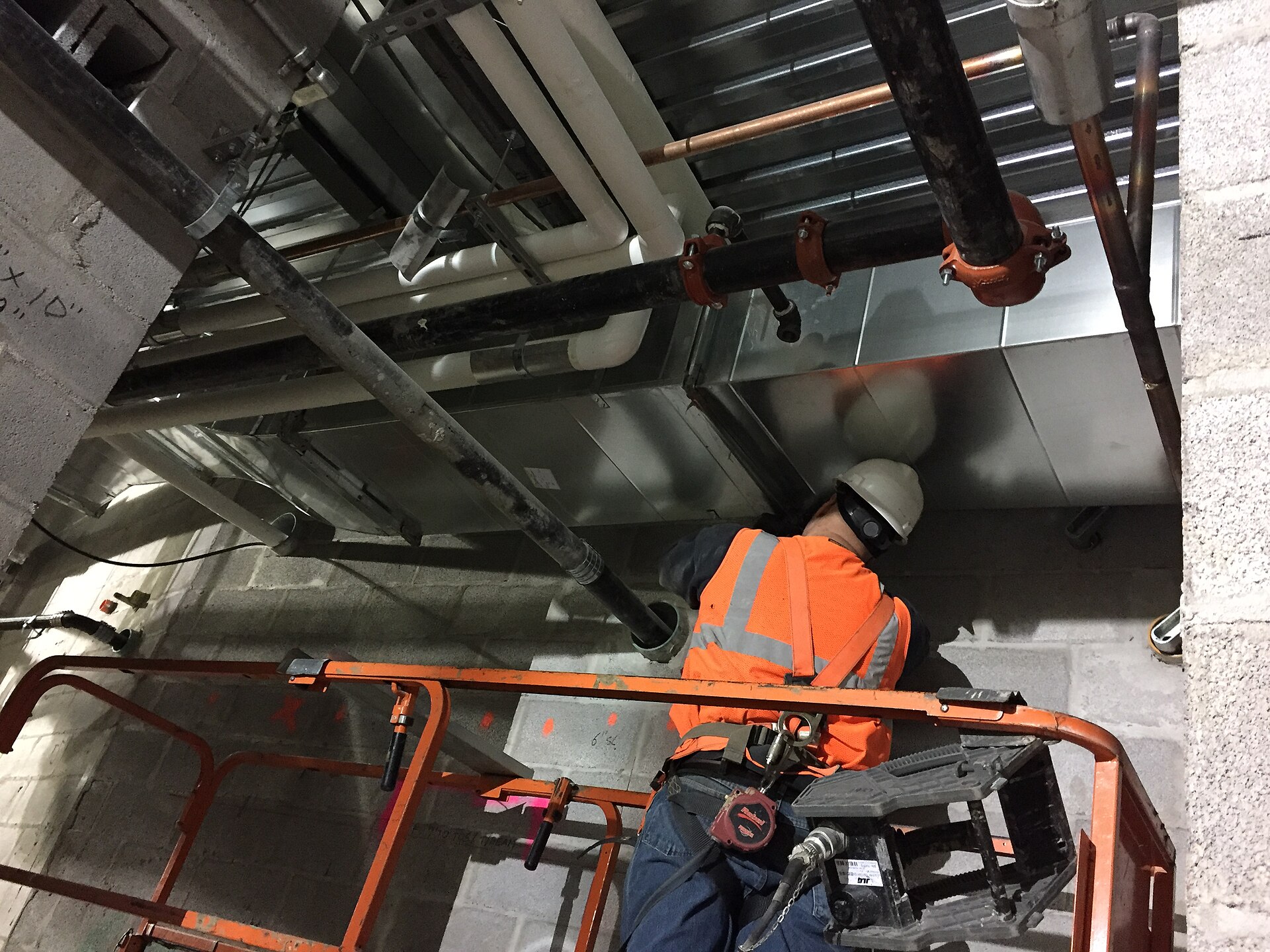 Galvanised HVAC ductwork running along a ceiling under construction
